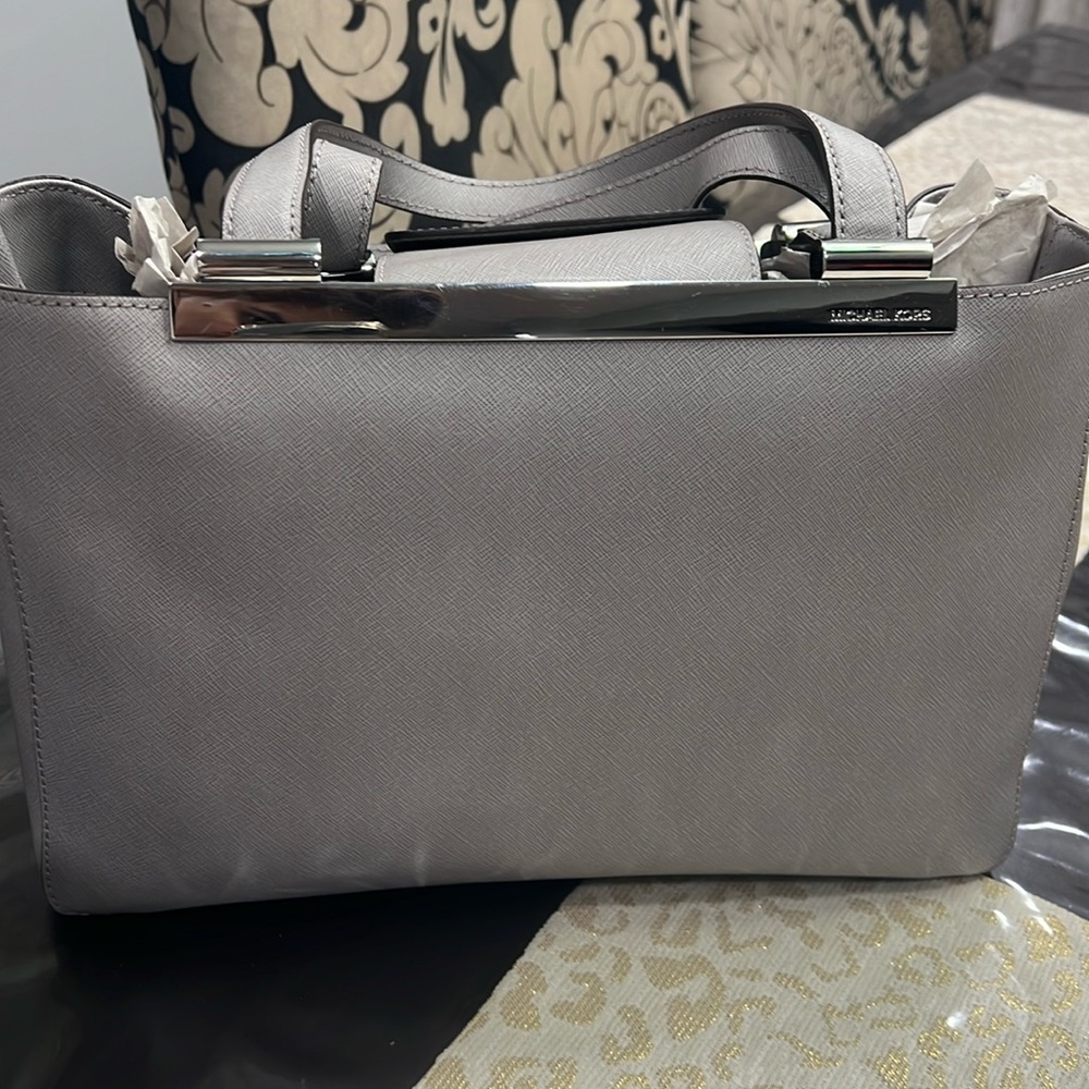 Pre owned Micheal kors bag ,length 9 inches ,width almost 13 inches